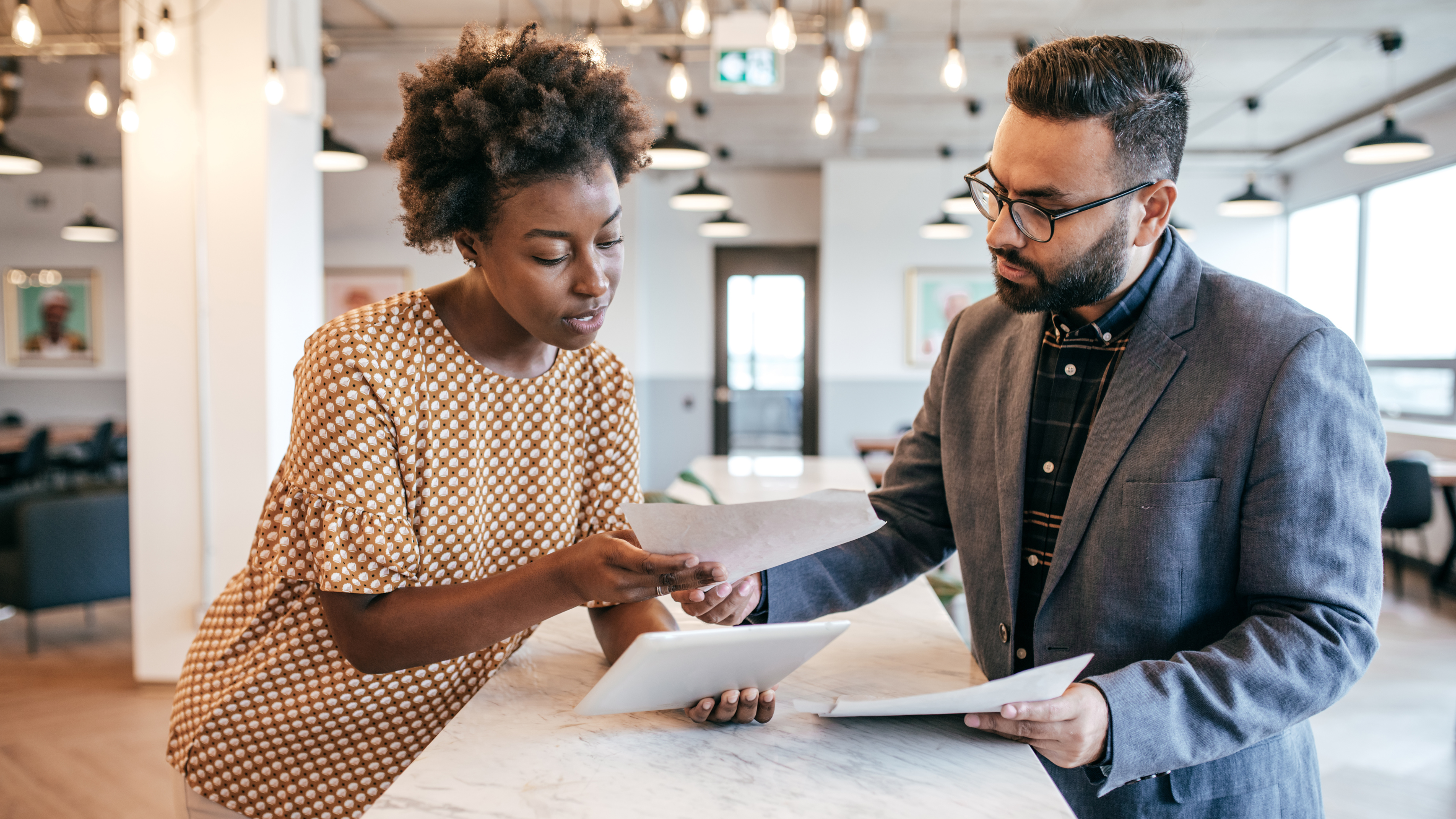 Small-business professionals reviewing operational documents